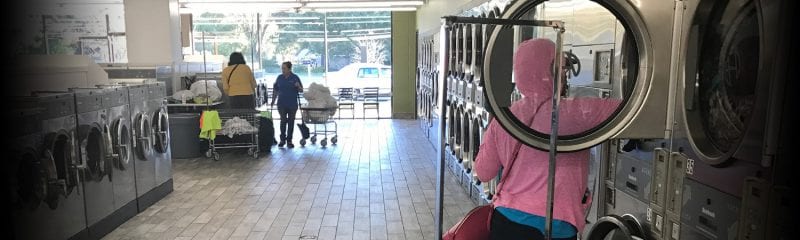 interior of laundromat facing front windows