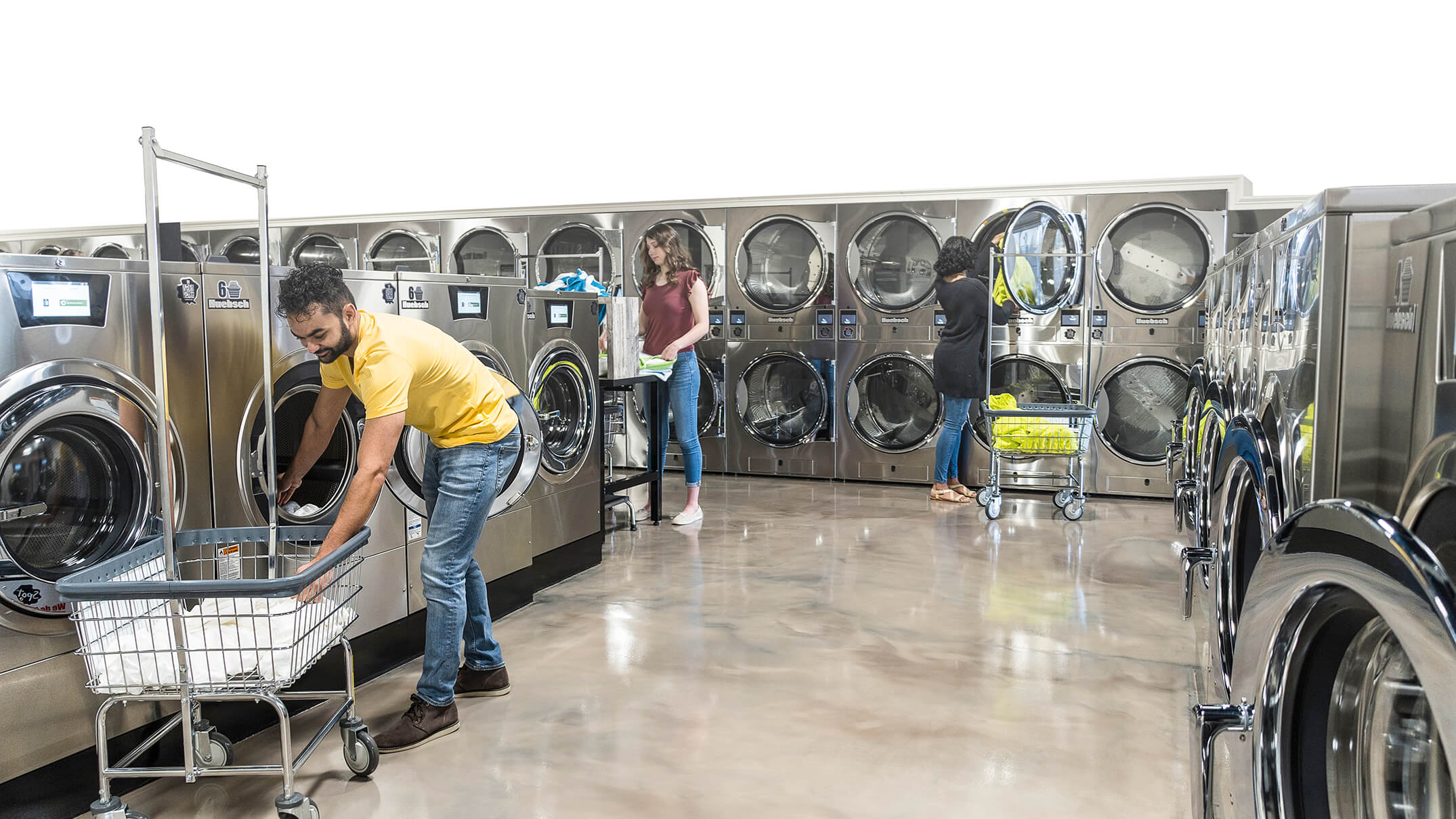 People doing laundry in Huebsch laundromat